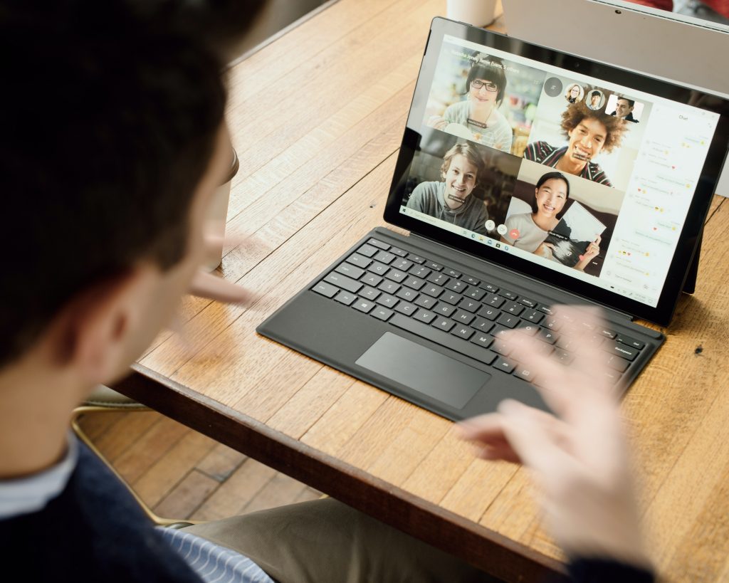Picture of one person on a laptop attending a virtual meeting.